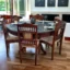 Glass Top 6 Seater Round Dining Table Set With Carving In Teak Wood
