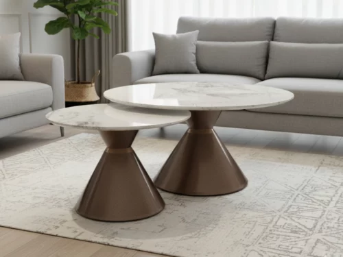 Pair of round coffee tables with white marble tops and bronze conical bases placed side by side on a white surface