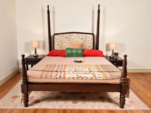 Mahogany four-poster bed with carved legs, floral upholstered headboard