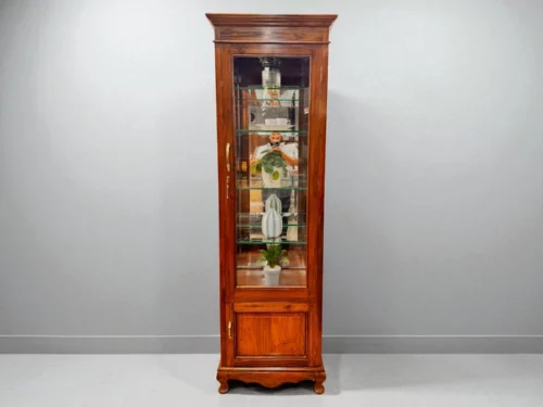 This Single Door Crockery Shelf is crafted from premium Kerala Teak wood, combining timeless elegance with practical design. The tall frame features a clear glass door and a mirrored back, creating a bright and spacious display for your finest crockery and collectibles. Inside, multiple glass shelves offer ample room for organized arrangement, while the polished teak finish adds warmth and richness to any interior. Ideal for dining rooms or living spaces, this piece is perfect for showcasing heirlooms, decor, or everyday essentials with style and sophistication.