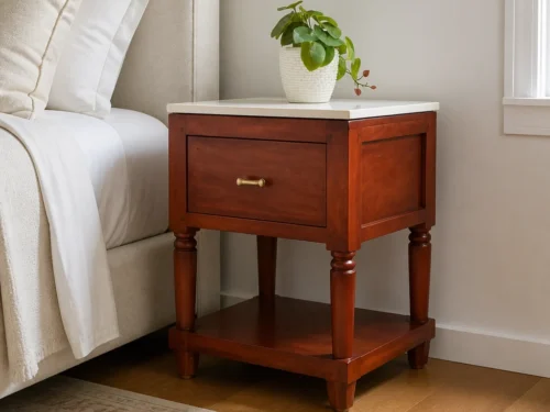 Sarah mahogany bed side table with tile top and one drawer beside a bed in a bedroom