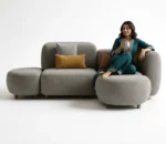 a female model sitting on fabric sofa set